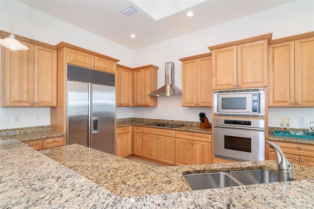 1375 Beach Road, Unit 309 Englewood, FL 34223 - Photo 17 of 45 a kitchen with stainless steel appliances granite countertop a stove a sink and a microwave