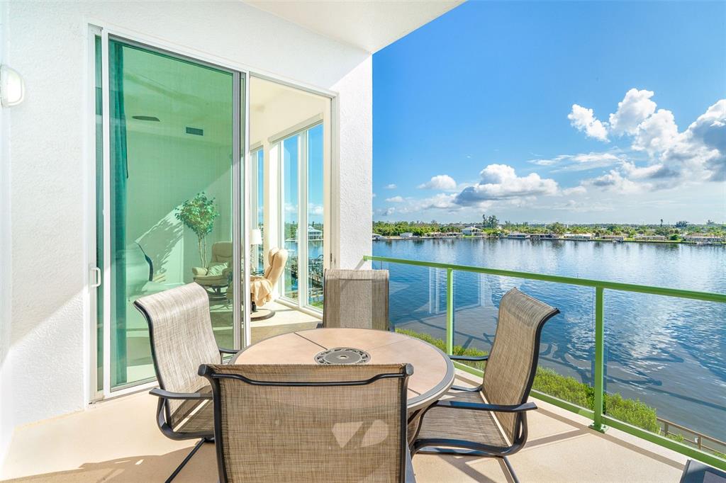 1375 Beach Road, Unit 309 Englewood, FL 34223 - Photo 27 of 45 a view of a dining room with furniture and a floor to ceiling window