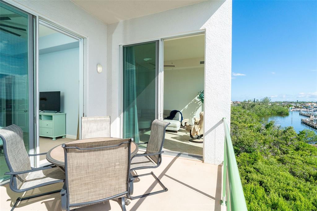 1375 Beach Road, Unit 309 Englewood, FL 34223 - Photo 29 of 45 a patio with yard glass top table and chairs