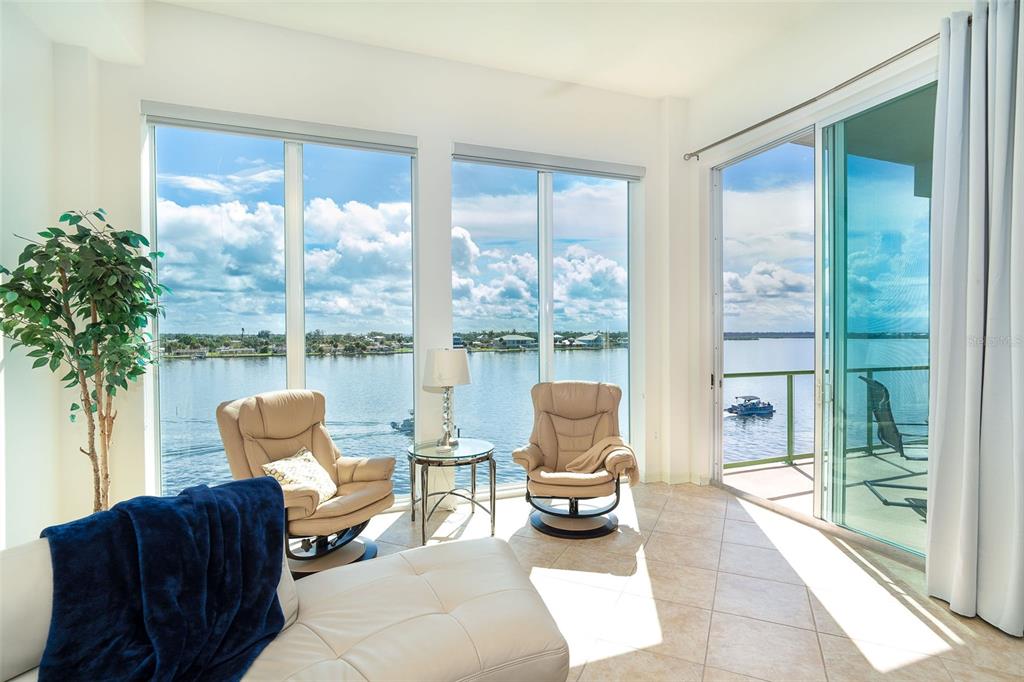 1375 Beach Road, Unit 309 Englewood, FL 34223 - Photo 34 of 45 a living room with furniture and a floor to ceiling window