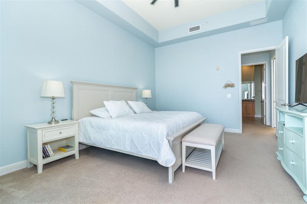 1375 Beach Road, Unit 309 Englewood, FL 34223 - Photo 38 of 45 a bedroom with a bed and a lamp on table