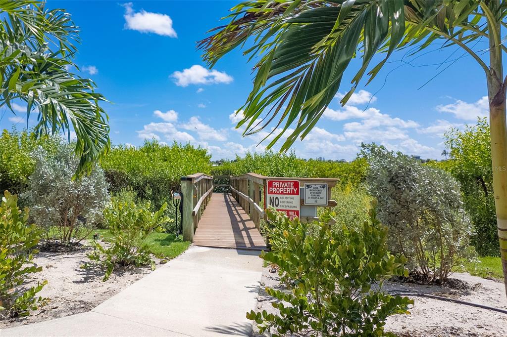 1375 Beach Road, Unit 309 Englewood, FL 34223 - Photo 43 of 45 a sign that is on the side of a road