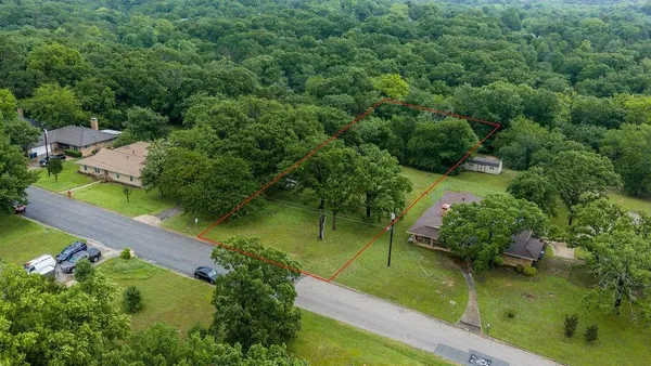 an aerial view of a house with a yard