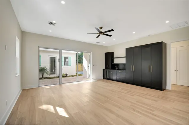 a large kitchen with stainless steel appliances kitchen island a sink and a refrigerator