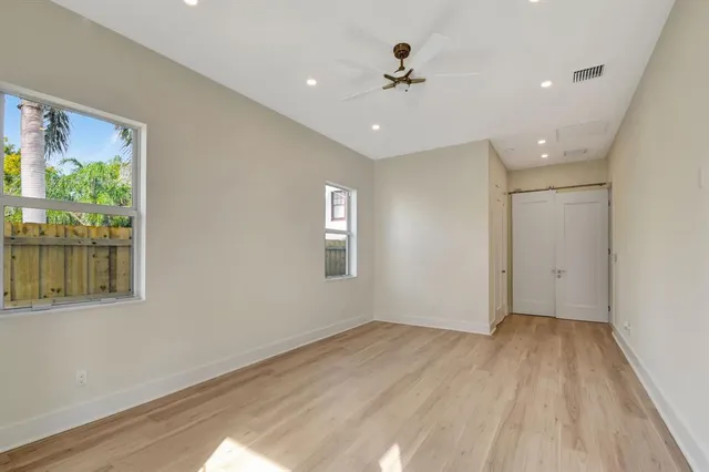 a bathroom with a granite countertop sink a mirror and a shower