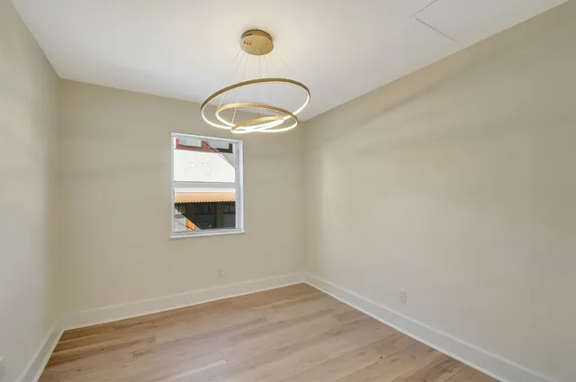 a large white kitchen with a large island oven a stove and white cabinets