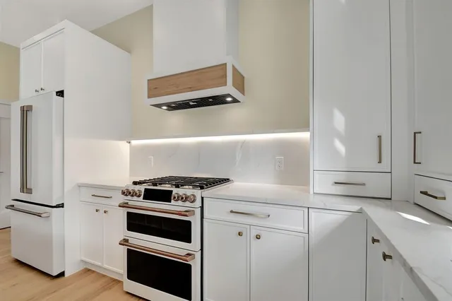 a large kitchen with granite countertop a stove and a sink
