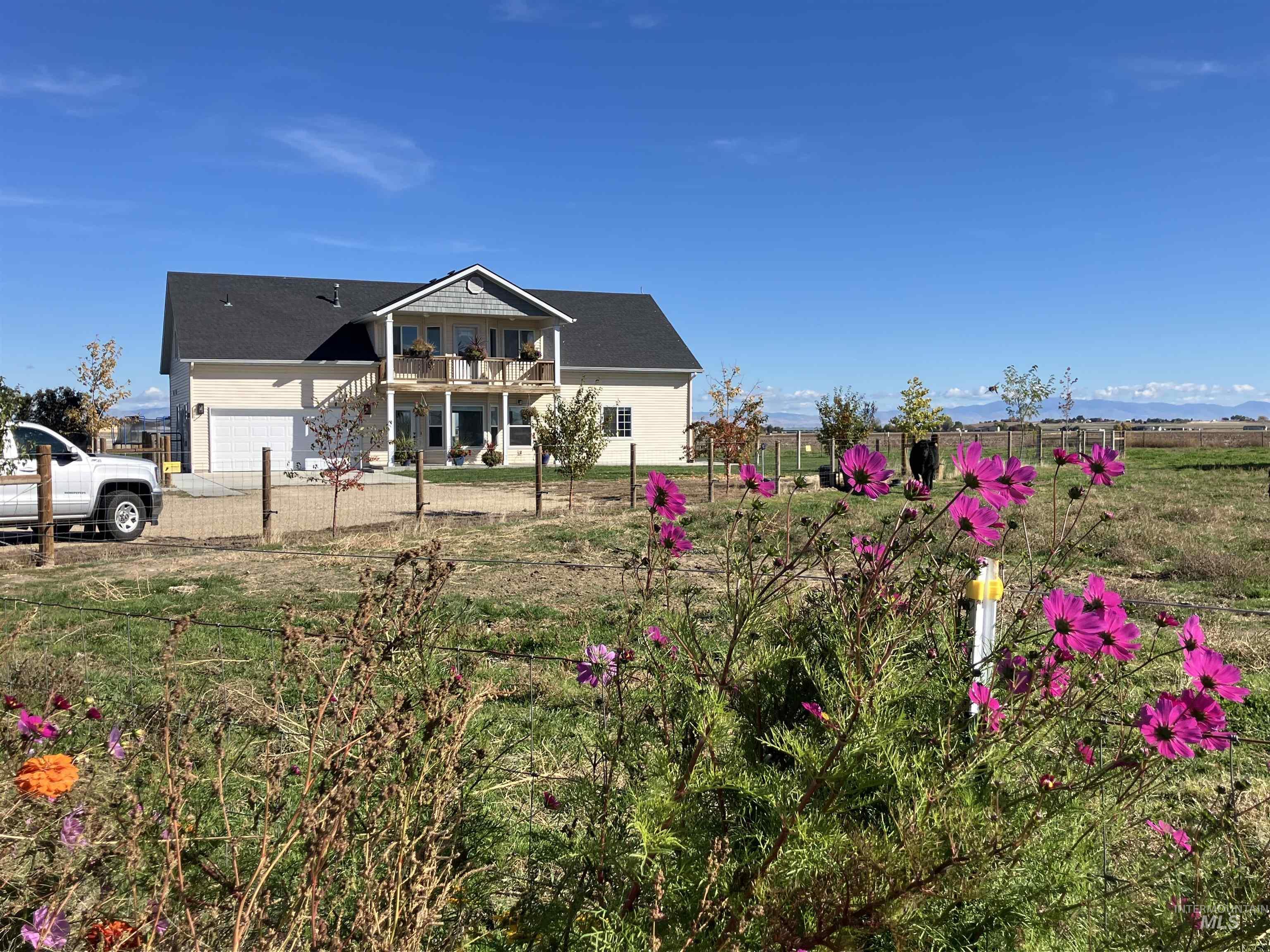 17530 Beet Road Caldwell, ID 83607 - Photo 2 of 50 View of front of home featuring a balcony and a garage