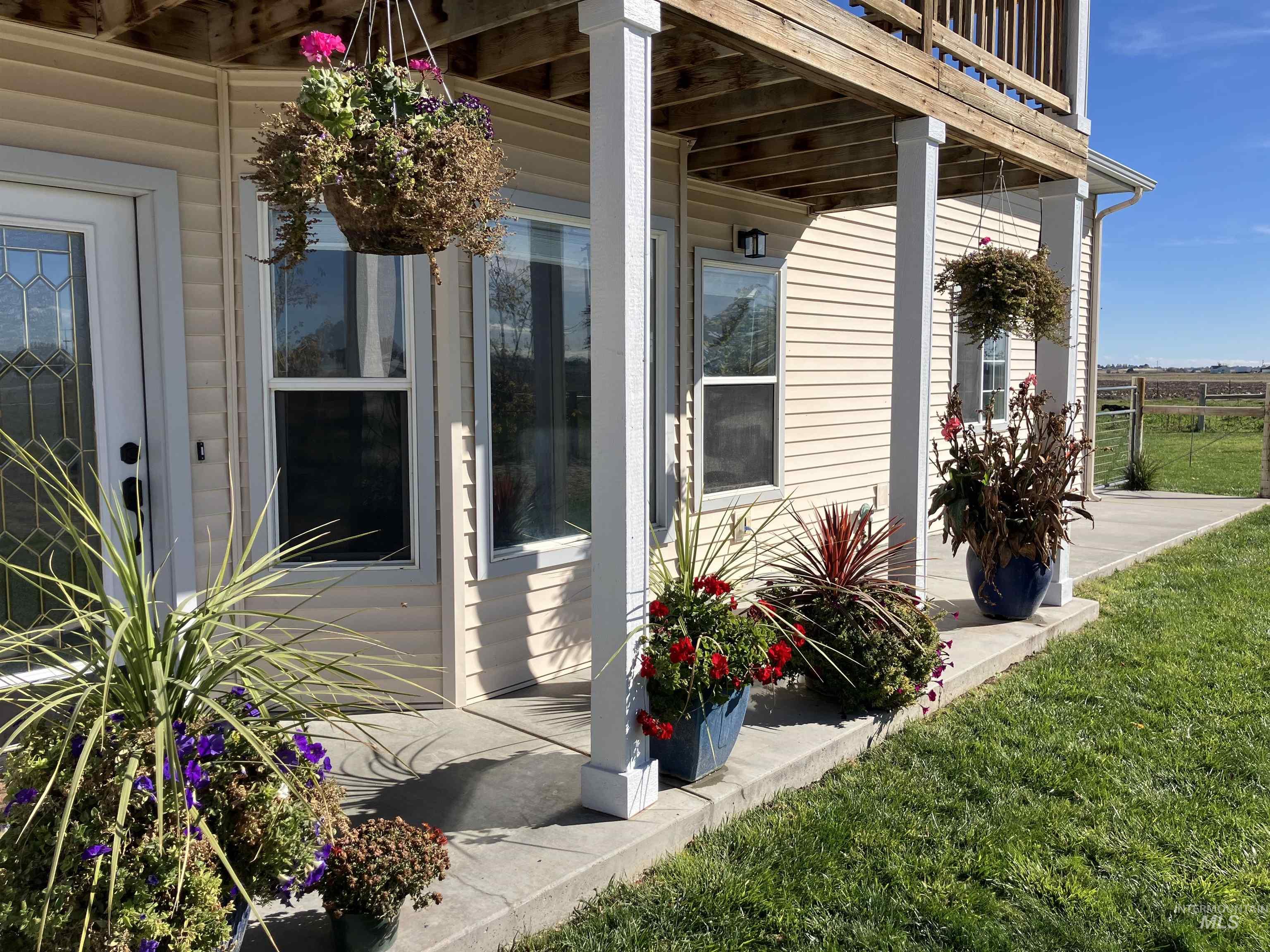 17530 Beet Road Caldwell, ID 83607 - Photo 3 of 50 View of exterior entry featuring a yard and flowers