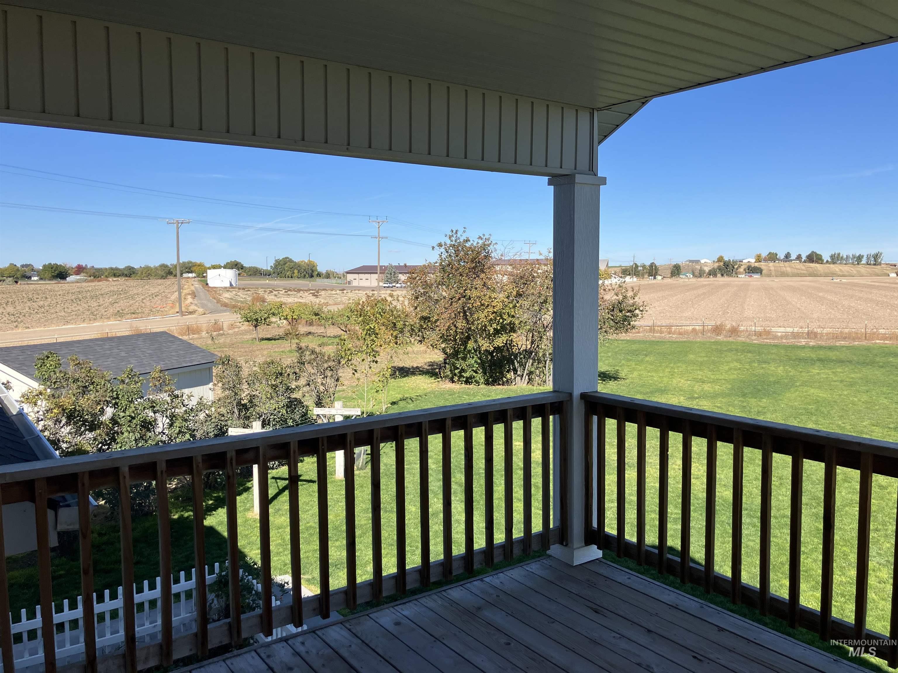 17530 Beet Road Caldwell, ID 83607 - Photo 39 of 50 Balcony from upper bedroom featuring a view of countryside and a lawn