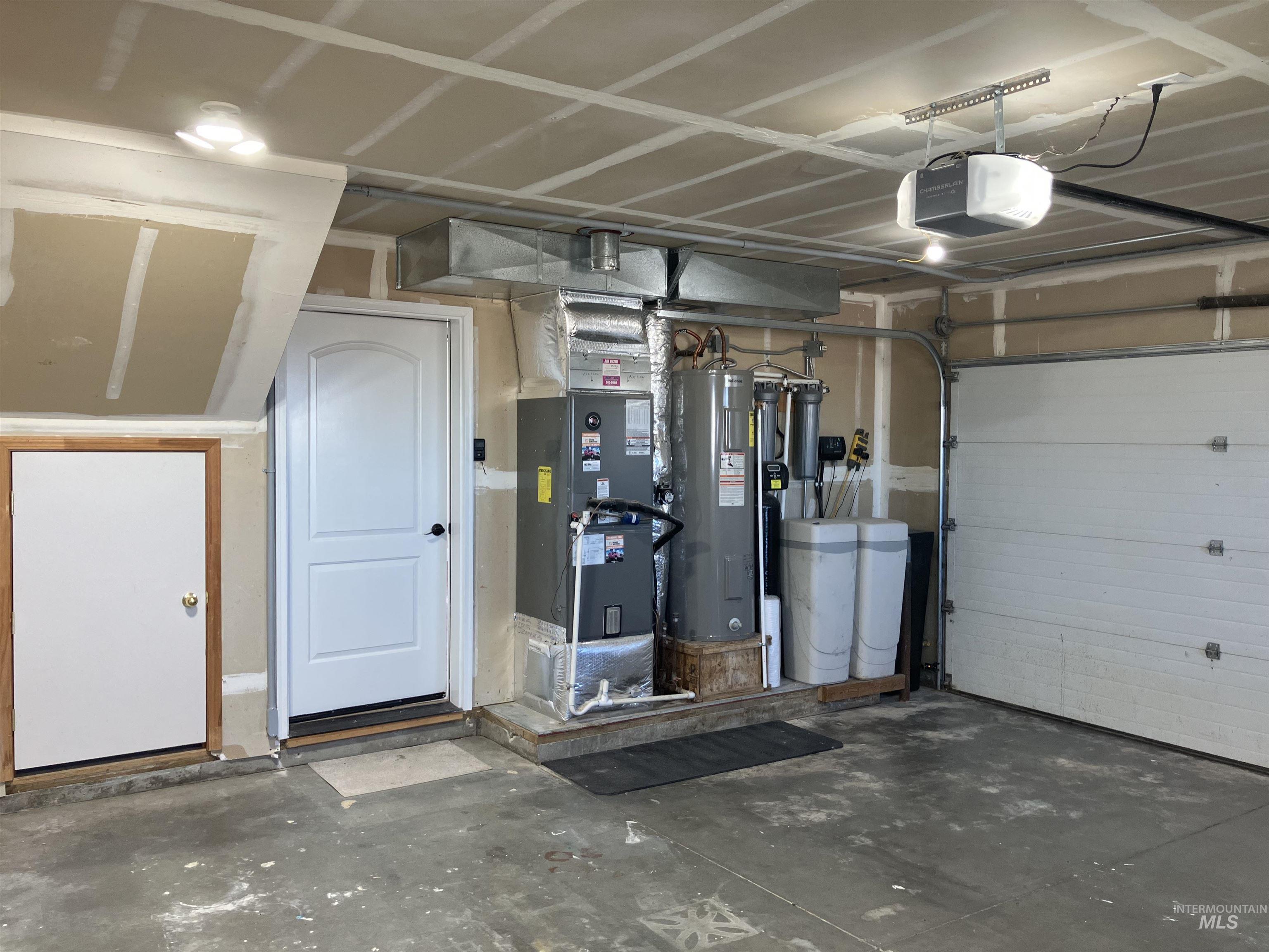 17530 Beet Road Caldwell, ID 83607 - Photo 44 of 50 Garage featuring electric water heater, heating unit, and a garage door opener