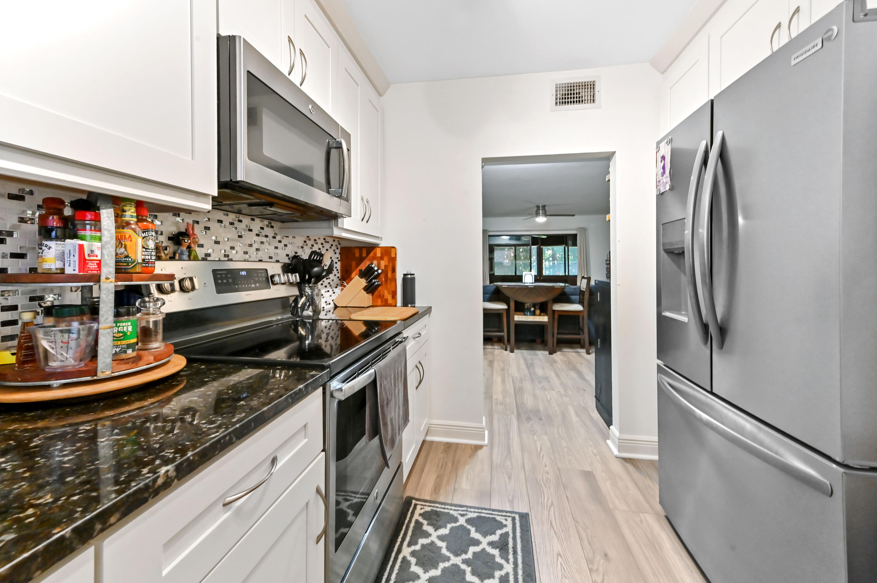 1230 Southeast Parkview Place, Unit D2 Stuart, FL 34994 - Photo 11 of 34 a kitchen with stainless steel appliances granite countertop a refrigerator and a stove