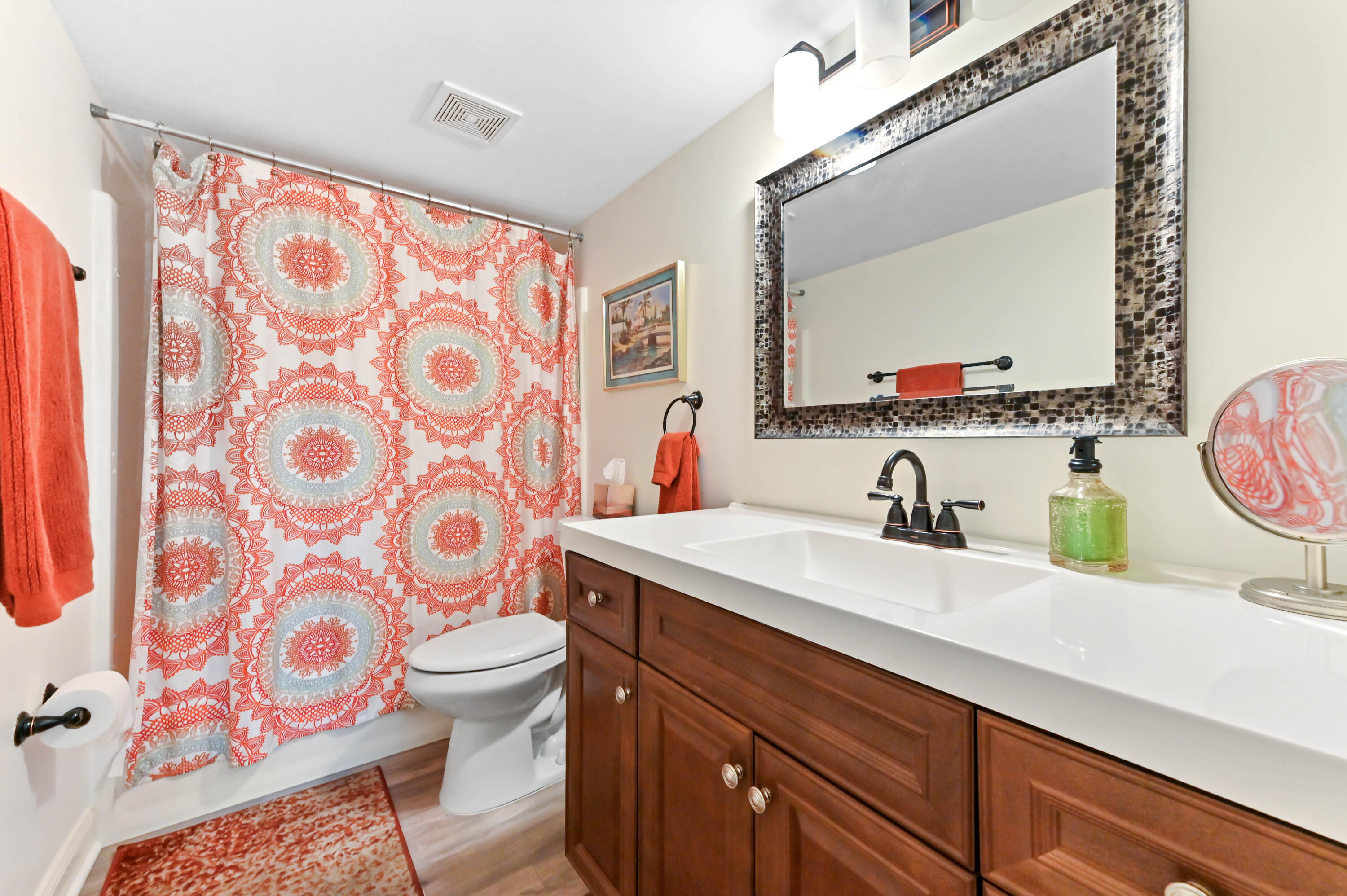 1230 Southeast Parkview Place, Unit D2 Stuart, FL 34994 - Photo 16 of 34 a bathroom with a sink mirror vanity and toilet