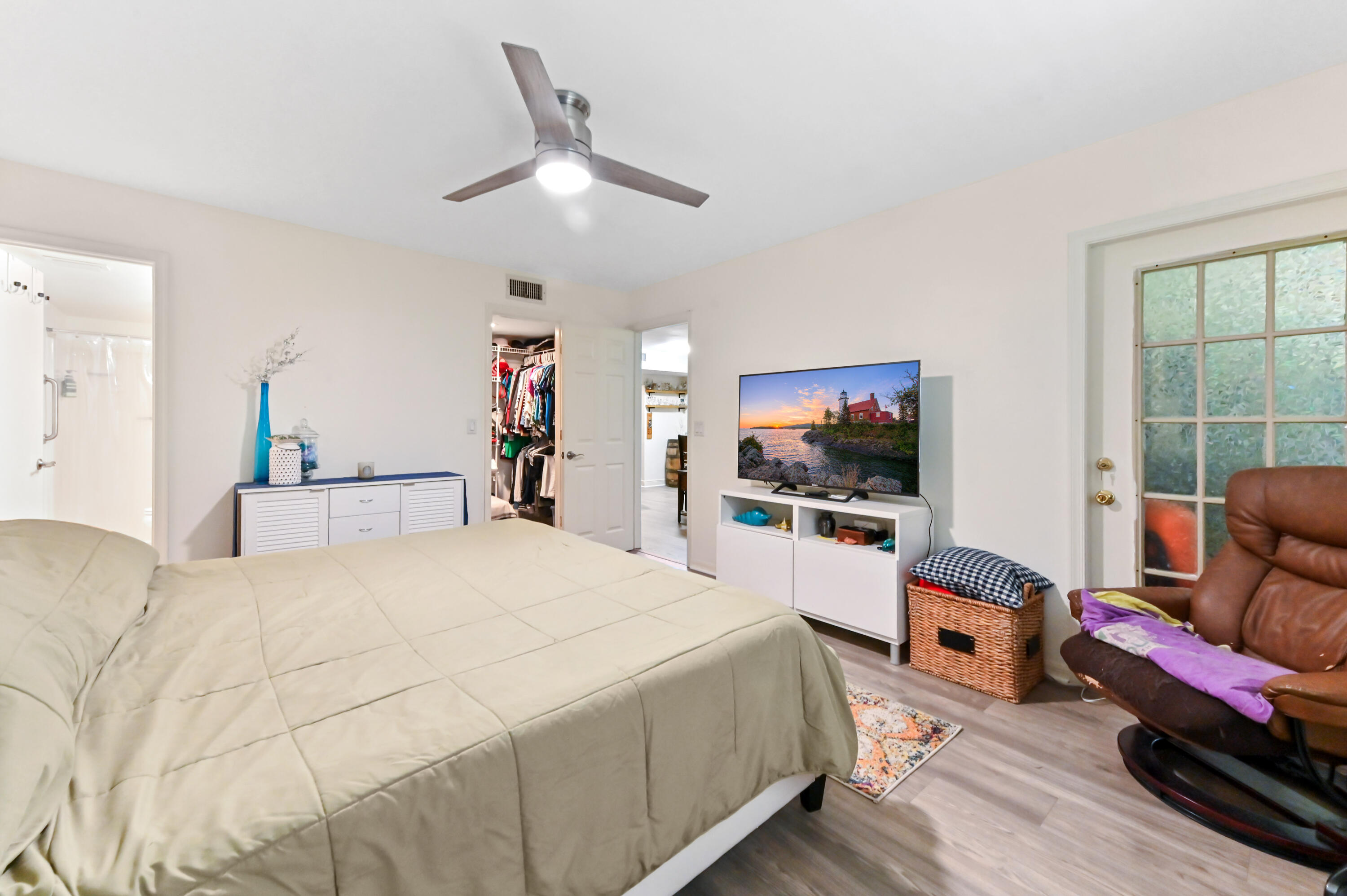 1230 Southeast Parkview Place, Unit D2 Stuart, FL 34994 - Photo 18 of 34 a bedroom with a bed and a flat screen tv