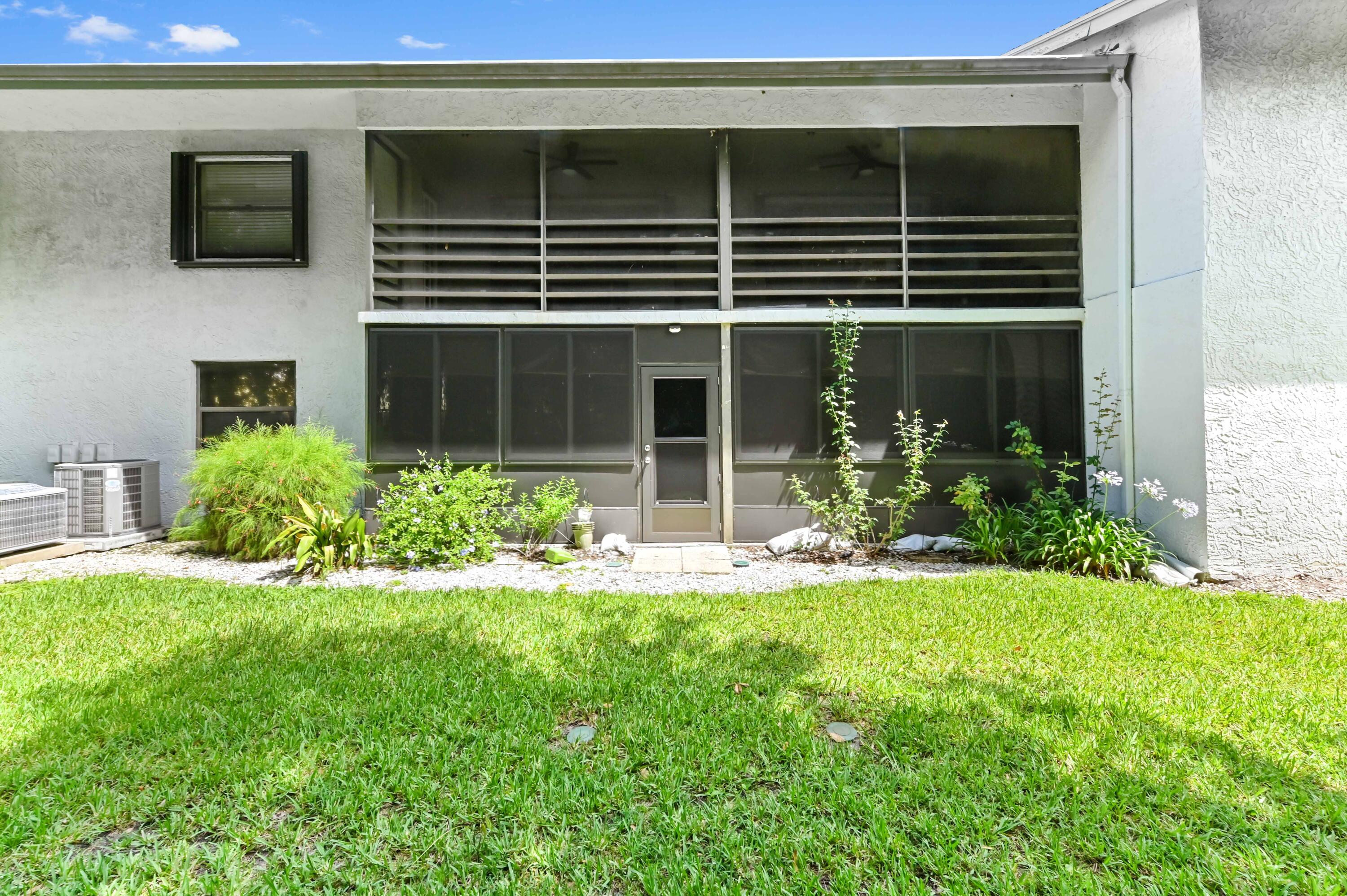 1230 Southeast Parkview Place, Unit D2 Stuart, FL 34994 - Photo 33 of 34 a view of a house with backyard and porch