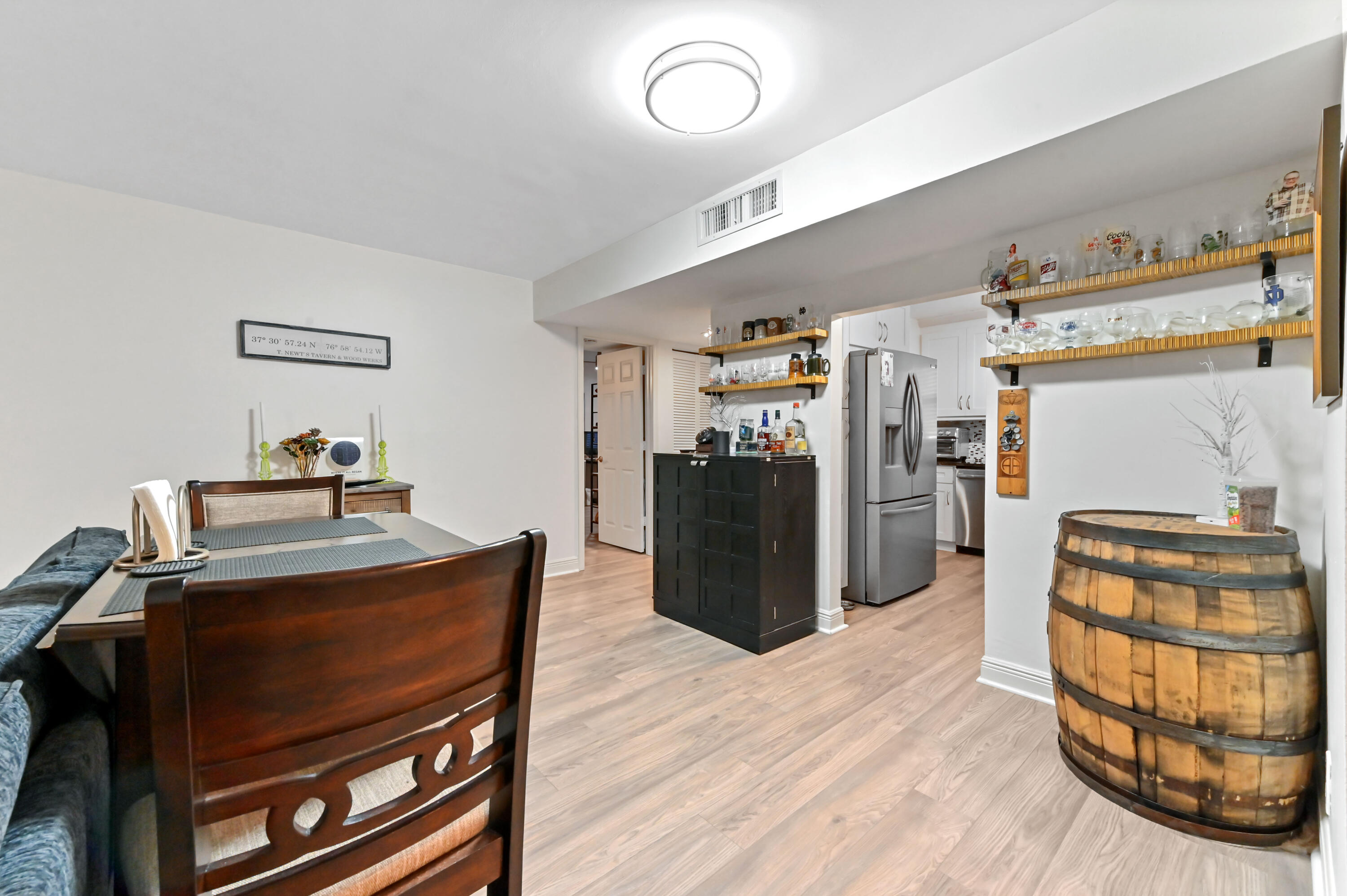 1230 Southeast Parkview Place, Unit D2 Stuart, FL 34994 - Photo 8 of 34 a kitchen with stainless steel appliances wooden floor and chairs