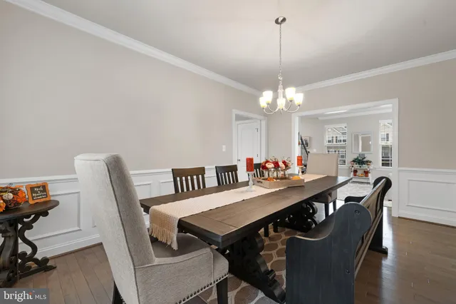 a spacious bedroom with a bed and a chandelier