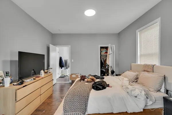 a room with a bed and a flat screen tv