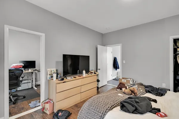 a bedroom with a bed and a flat tv screen