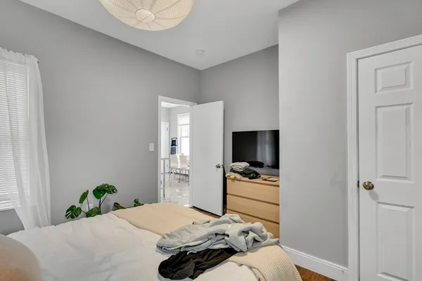 a bedroom with a bed and flat screen tv