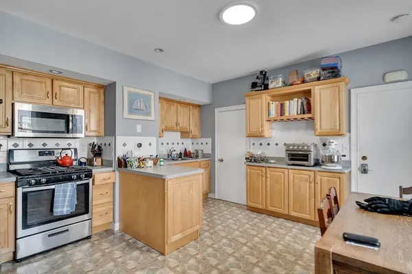 a kitchen with stainless steel appliances a stove sink and cabinets