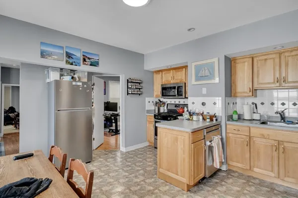 a kitchen with granite countertop a sink stove and refrigerator