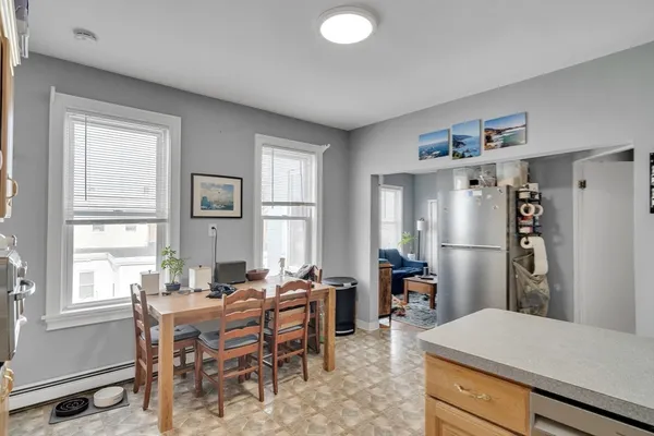 a living room with furniture a large window and table