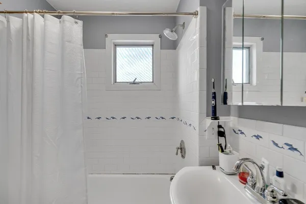 a bathroom with a sink and a shower curtain