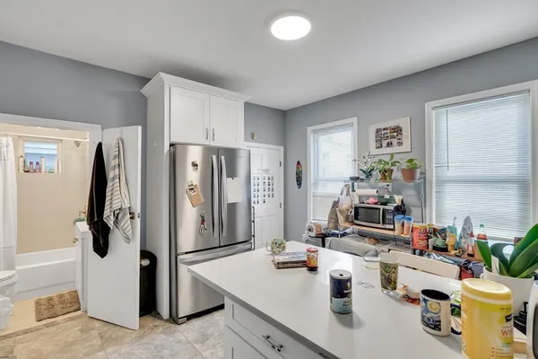 a kitchen with a refrigerator and a sink