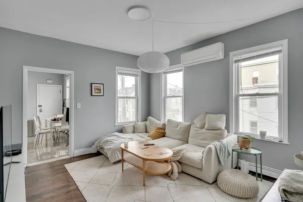 a living room with furniture and a chandelier