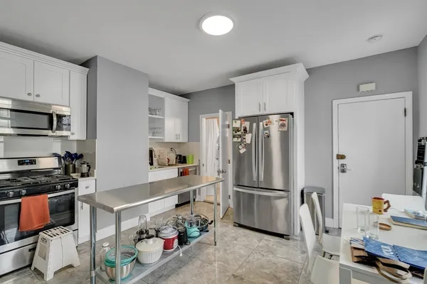 a kitchen with stainless steel appliances granite countertop a refrigerator stove and a sink