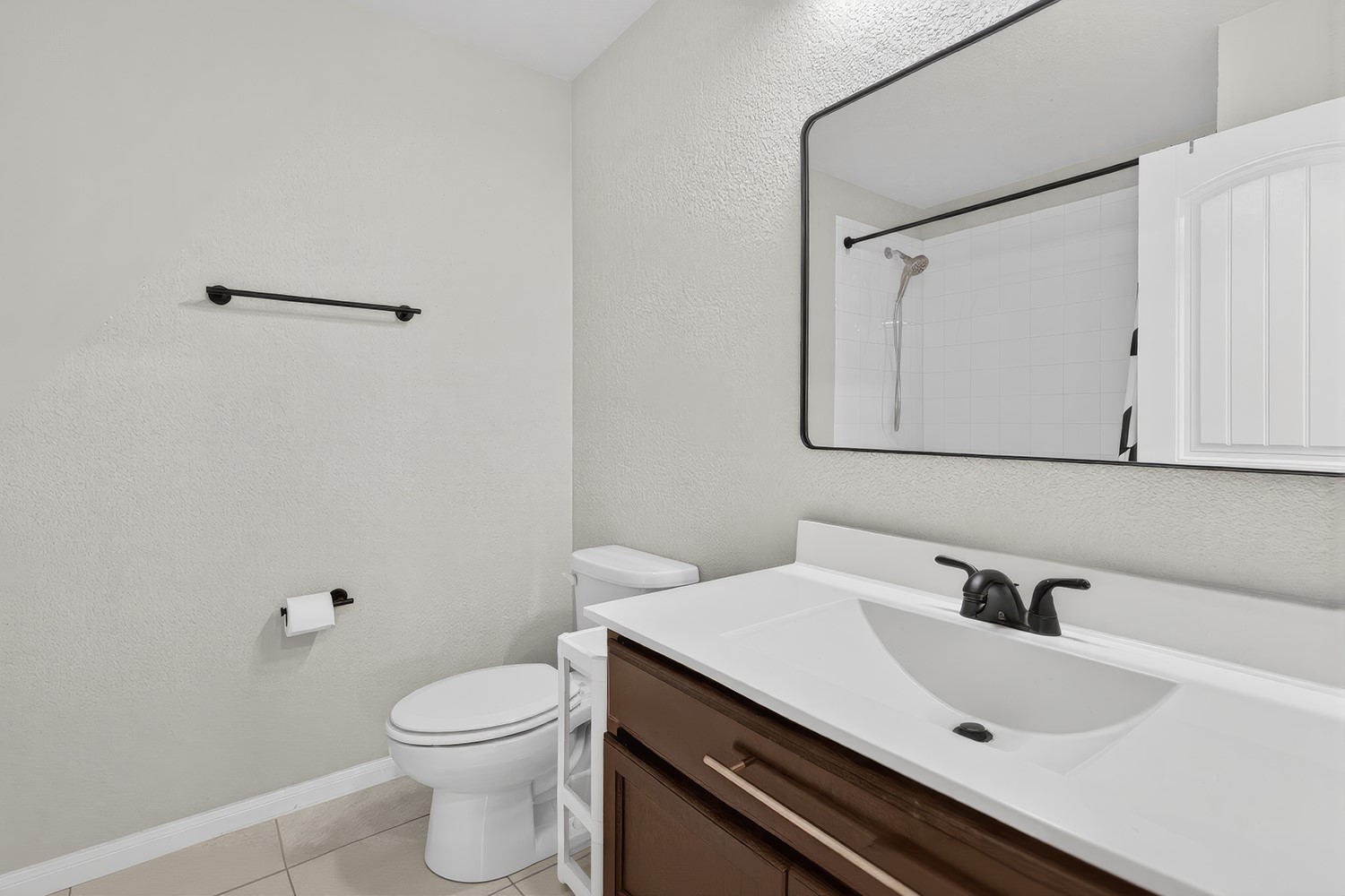 2006 Grow Lane Austin, TX 78754 - Photo 19 of 40 A well-lit guest bathroom features a modern vanity with ample counter space and a sleek mirror reflecting the shower.