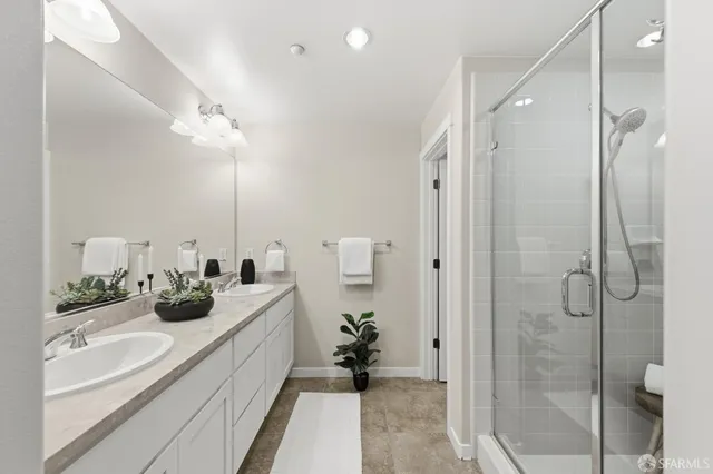 a bathroom with a double vanity sink and a mirror