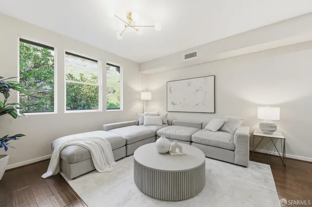 a living room with furniture kitchen view and a dining table
