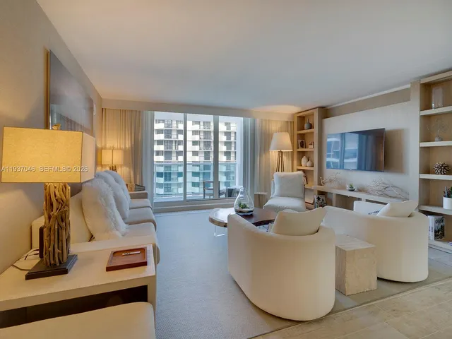 a living room with furniture large window and flat screen tv