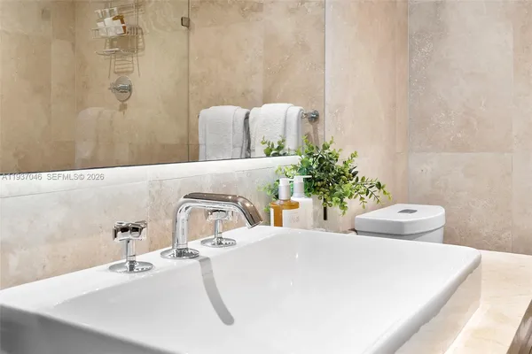 a bathroom with a tub and a potted plant