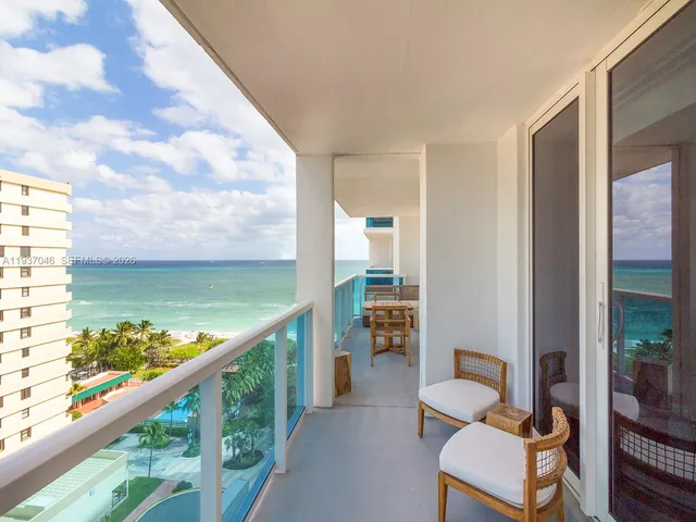 a balcony with chairs and a table