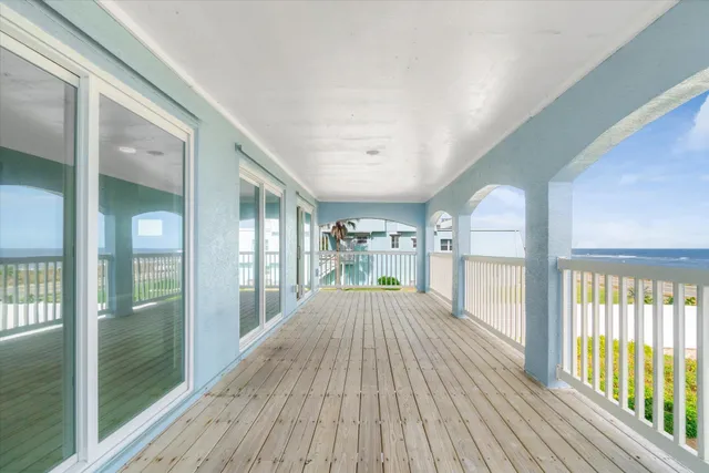 a view of an ocean with a building in the background