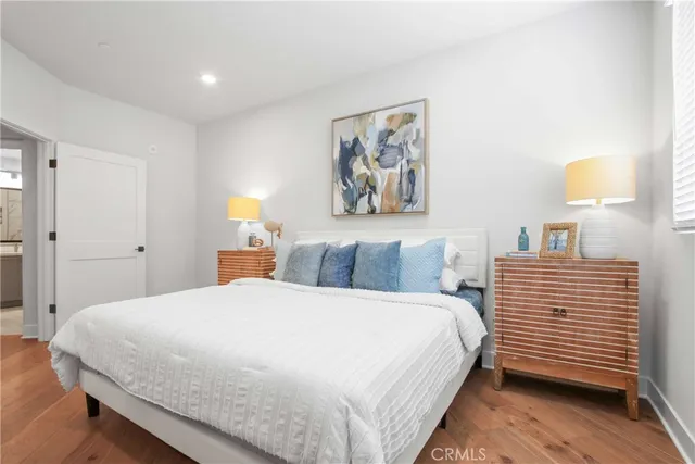 a bedroom with a bed and a painting on the wall