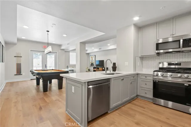 a kitchen with a stove a sink and a refrigerator