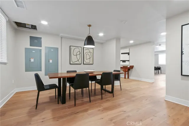 a view of a a dining room with furniture window and wooden floor