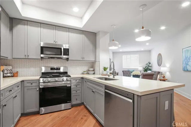 a kitchen with a sink stove and microwave