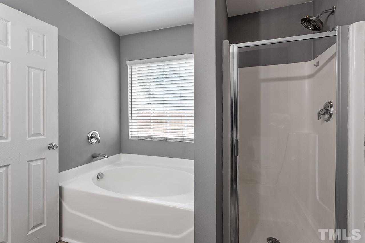 4236 Dalcross Road Raleigh, NC 27610 - Photo 11 of 14 a white bath tub sitting next to a white sink