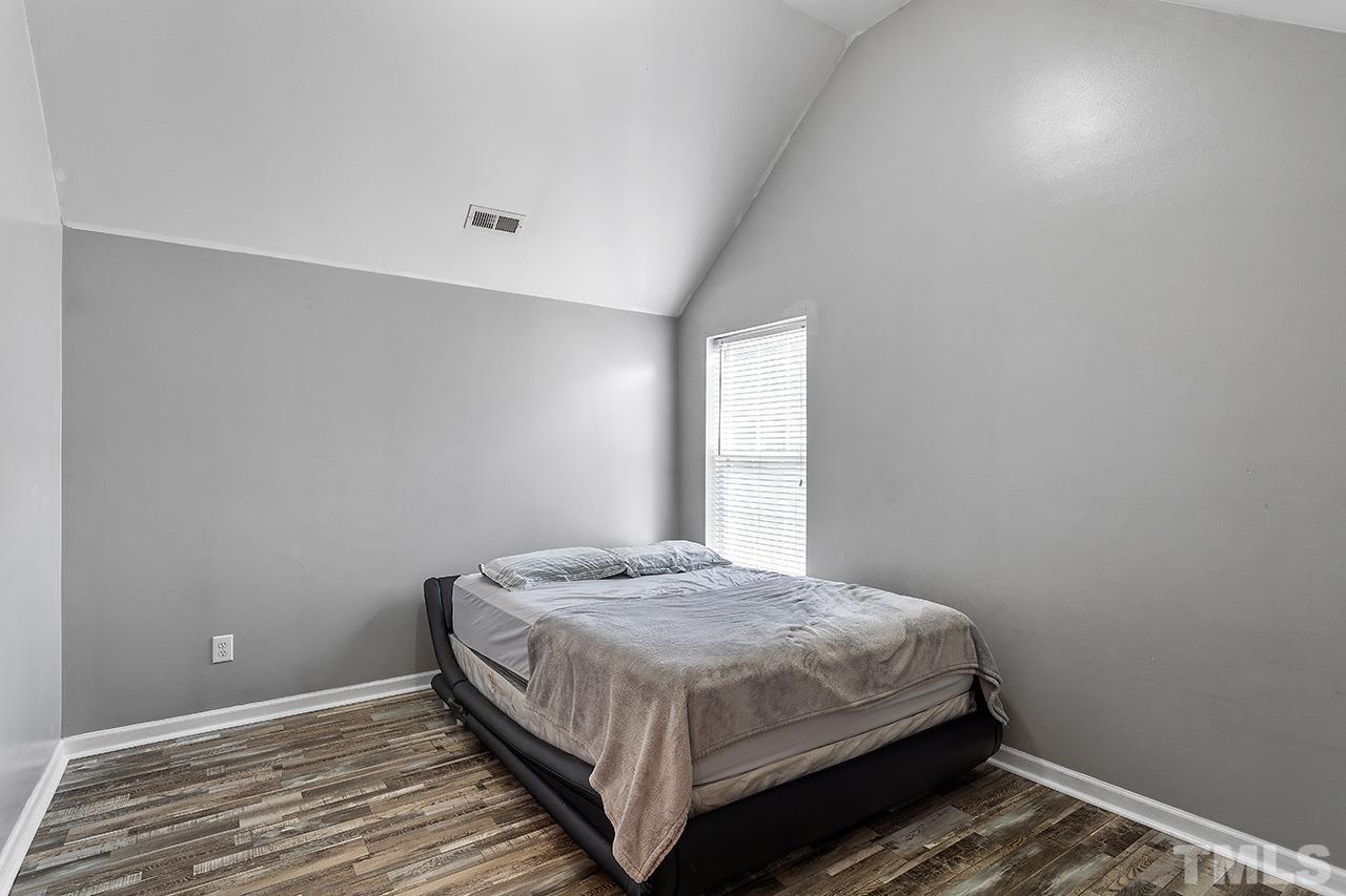4236 Dalcross Road Raleigh, NC 27610 - Photo 14 of 14 a bedroom with a bed and window