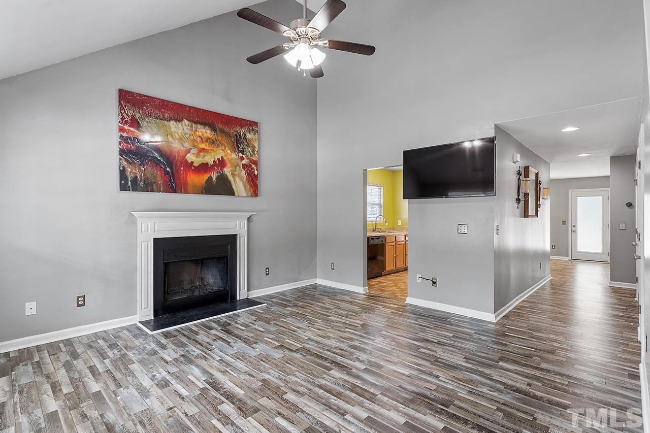 4236 Dalcross Road Raleigh, NC 27610 - Photo 4 of 14 a view of livingroom with flat screen tv and fireplace