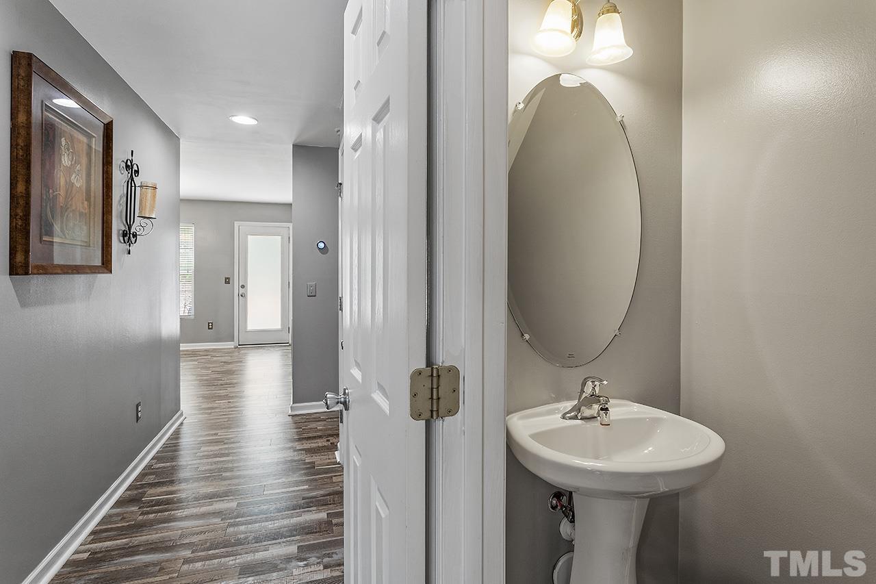 4236 Dalcross Road Raleigh, NC 27610 - Photo 6 of 14 a bathroom with a sink and mirror