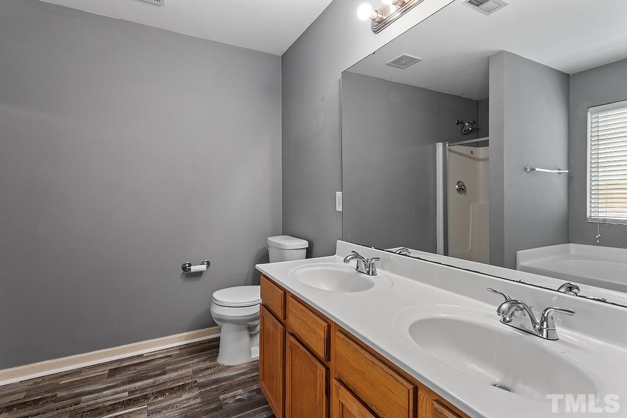 4236 Dalcross Road Raleigh, NC 27610 - Photo 10 of 14 a bathroom with a sink and a toilet