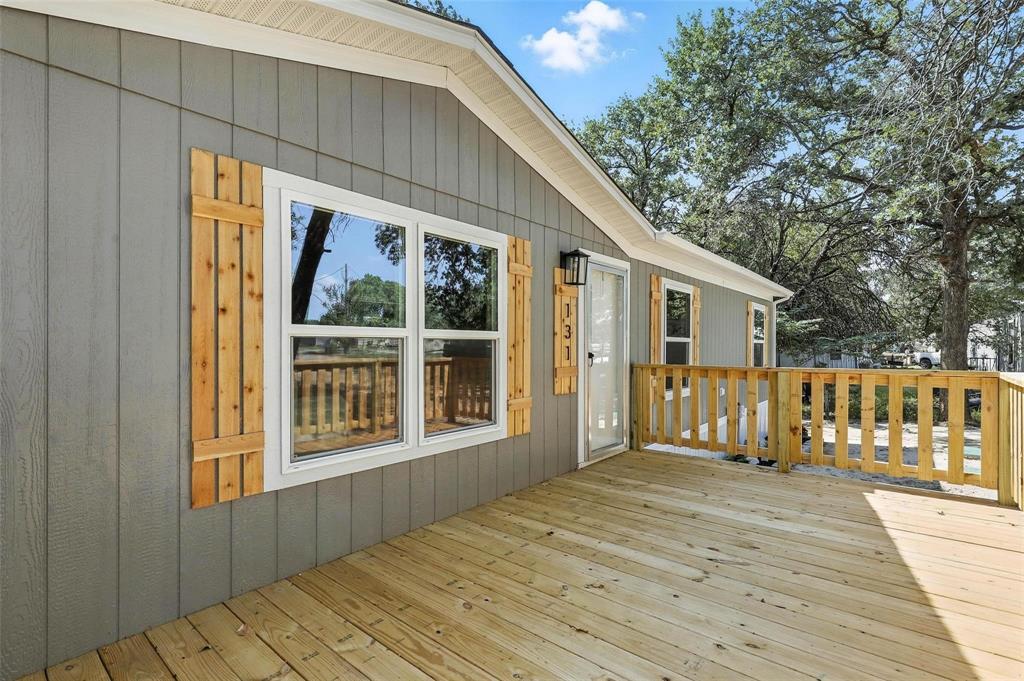 131 Kelly Court Azle, TX 76020 - Photo 19 of 22 a view of backyard with deck and wooden floor