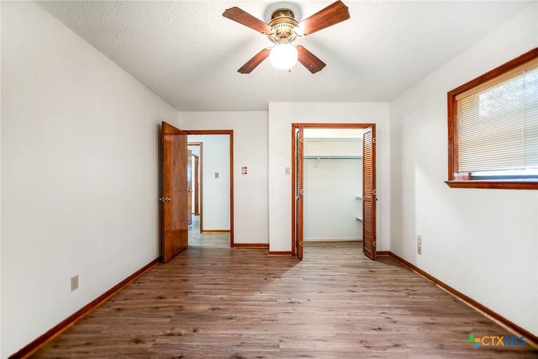 181 Pecan Street Port Lavaca, TX 77979 - Photo 15 of 34 wooden floor in an empty room with a window