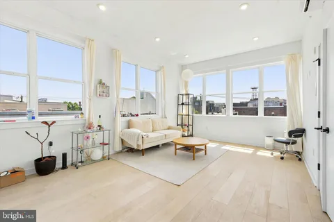a bedroom with furniture and a large window